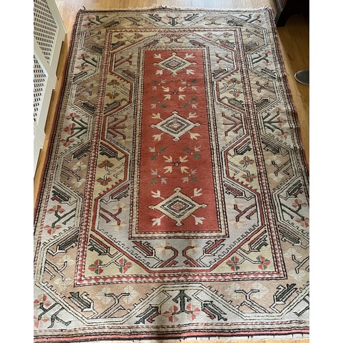1126 - A vintage wool rug in shades of orange. 246 w x 170cm d.