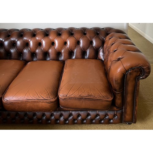 148 - A brown leather button backed sofa 187 l x 87cm d.