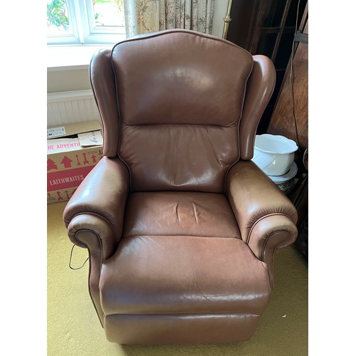 151 - Two electrically operated brown leather reclining chairs.