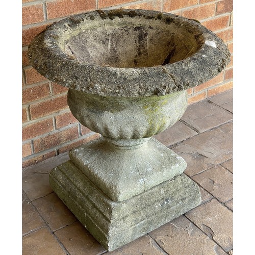 201 - A reconstituted stone urn. 60cm d x 64cm h.