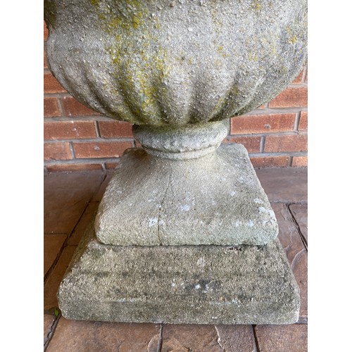 201 - A reconstituted stone urn. 60cm d x 64cm h.