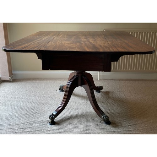 196 - A 19thC mahogany breakfast/dining table on centre turned support with brass lions paw feet and casto... 