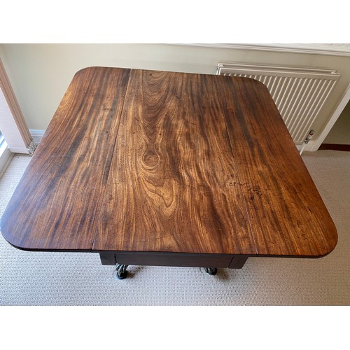 196 - A 19thC mahogany breakfast/dining table on centre turned support with brass lions paw feet and casto... 