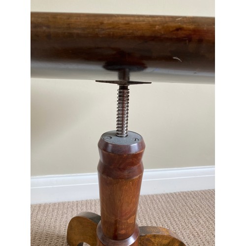 197 - An extending mahogany piano stool with curved seat to top. 57 h x 36.5 w at top.