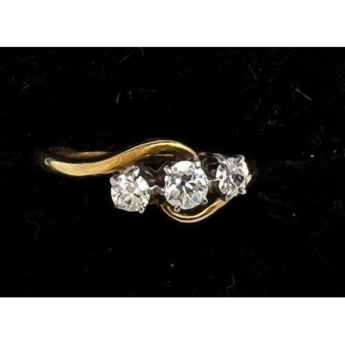 649 - A three stone diamond ring marked 18ct. Weight 3gm. Size L.