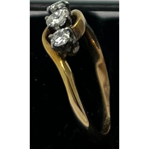 649 - A three stone diamond ring marked 18ct. Weight 3gm. Size L.