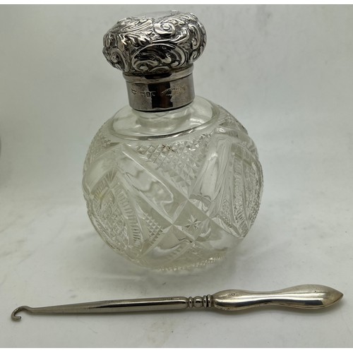 839 - A cut glass scent bottle with hallmarked silver top London 1896 maker Mappin & Webb with a silver ha... 