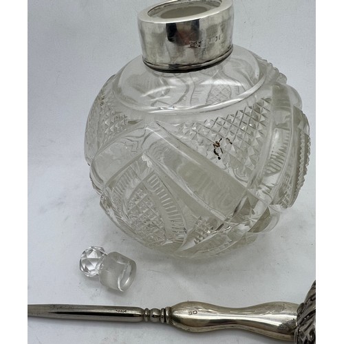 839 - A cut glass scent bottle with hallmarked silver top London 1896 maker Mappin & Webb with a silver ha... 