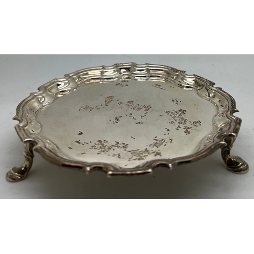 847 - A silver card tray raised on legs, London 1732 maker D.L. (Denis Langton). Weight 164gm.