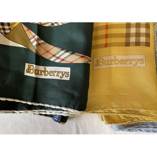 753 - A collection of seven Silk scarf to include 2 x Burberry with the classic check pattern, 2 x Liberty... 