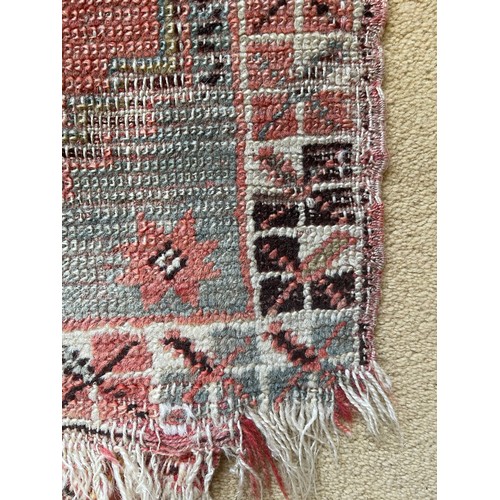 1124 - A woven prayer rug mostly red hues 48cms w x 86cms l.