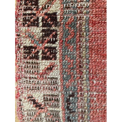 1124 - A woven prayer rug mostly red hues 48cms w x 86cms l.