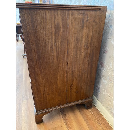 20A - An early 19thC mahogany chest of drawers on bracket feet with brass handles.