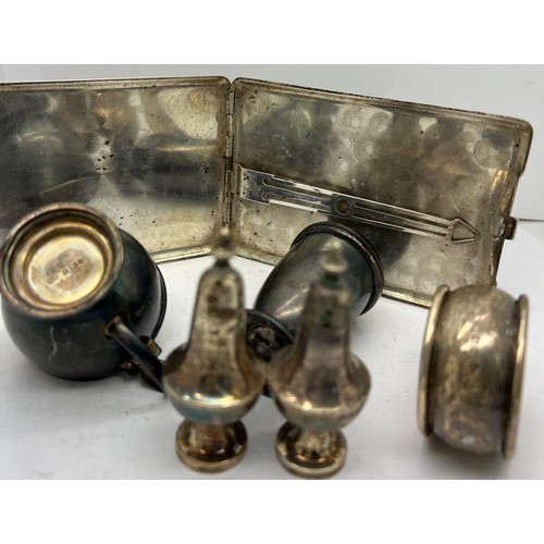 899 - Hallmarked silver mustard pot, pepperette, pair of pepperettes, napkin ring and a sterling silver ci... 