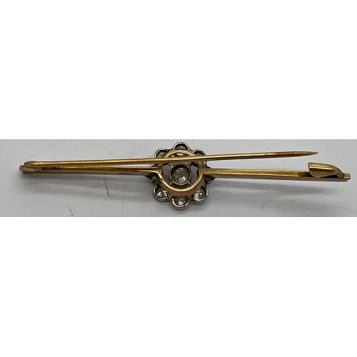 590 - An unmarked yellow and white metal diamond set bar brooch 6.5cm l.