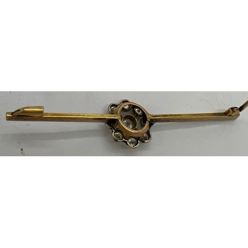 590 - An unmarked yellow and white metal diamond set bar brooch 6.5cm l.