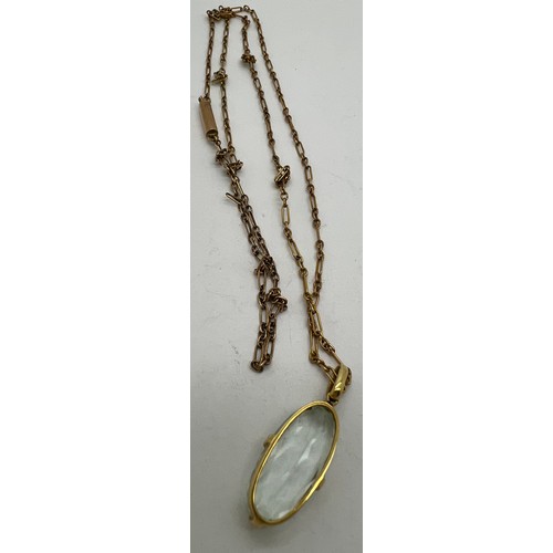 593 - A 9ct gold chain with pale blue stone pendant. Chain 50cm l.