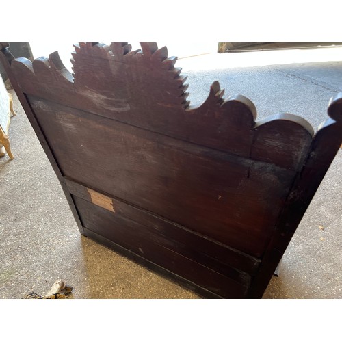 122 - A dark oak settle with deeply carved back and lift up seat. 107 w x 122 h x 58cm d.