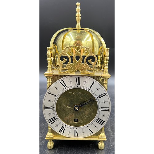 1036 - An 8 day brass lantern style mantle clock. The single train movement by Empire has platform escapeme... 