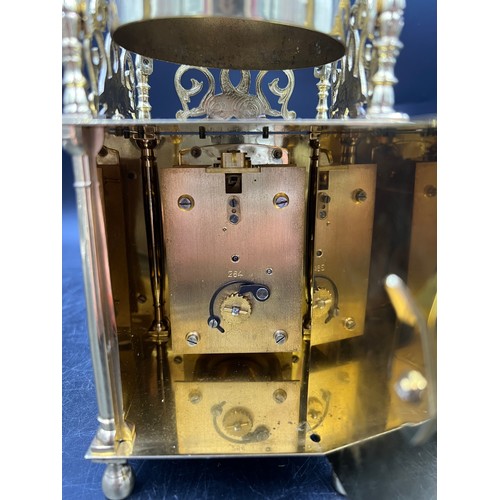 1036 - An 8 day brass lantern style mantle clock. The single train movement by Empire has platform escapeme... 