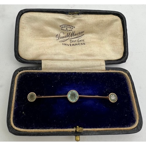 575 - A 9ct gold bar brooch set with 3 blue stones in original presentation box. 5cm l. 1.8gm.