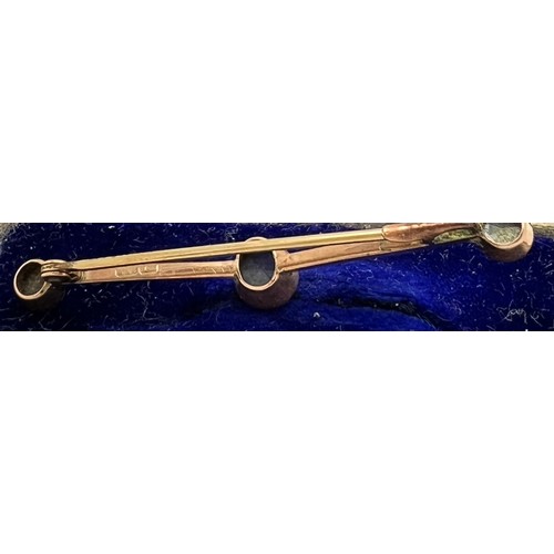 575 - A 9ct gold bar brooch set with 3 blue stones in original presentation box. 5cm l. 1.8gm.