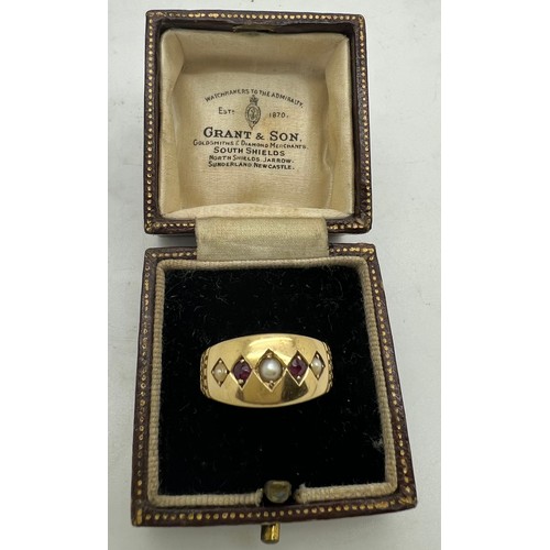 578 - An 18ct gold ring set with seed pearls and red stones. Weight 2.6gm. Size L.