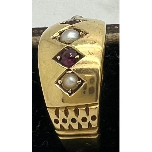 578 - An 18ct gold ring set with seed pearls and red stones. Weight 2.6gm. Size L.