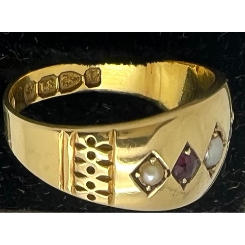 578 - An 18ct gold ring set with seed pearls and red stones. Weight 2.6gm. Size L.