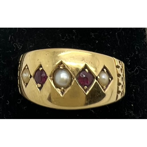 578 - An 18ct gold ring set with seed pearls and red stones. Weight 2.6gm. Size L.