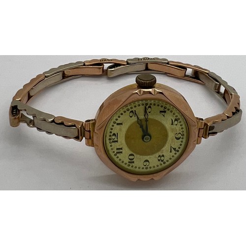 916 - A 9ct gold cased ladies wristwatch on expanding rolled gold bracelet in original presentation case. ... 