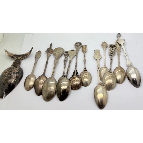 908 - Thirteen various commemorative spoons to include .800 silver and white metal contained in a non rela... 