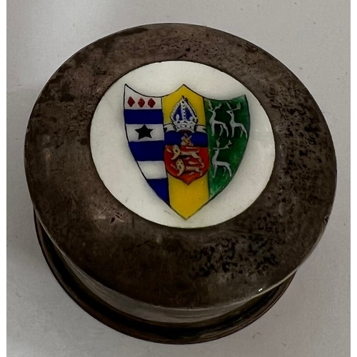 909 - A circular silver lidded box with enamelled shield to top. Chester 1919. Approx. weight 20.2gm. 4cm ... 