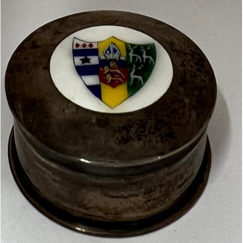 909 - A circular silver lidded box with enamelled shield to top. Chester 1919. Approx. weight 20.2gm. 4cm ... 