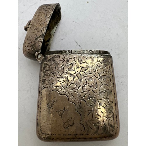 910 - A hallmarked silver foliate engraved vesta case. Birmingham 1898 maker J R Ltd, initialled to front ... 