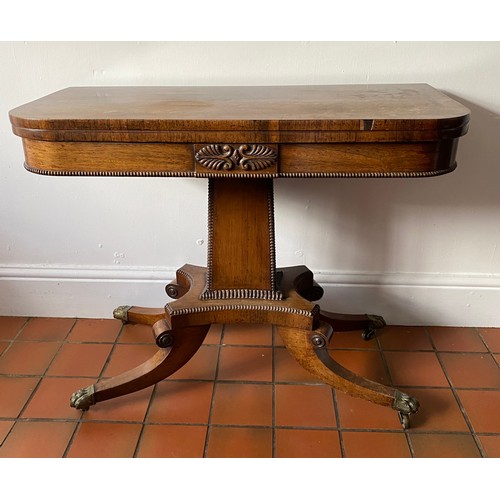 126 - A Regency rosewood card table with red baize interior with brass lions paw feet. 73cm h.  89 x 91.5c... 