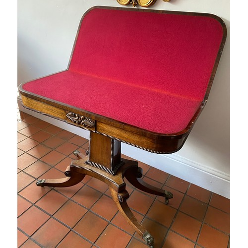 126 - A Regency rosewood card table with red baize interior with brass lions paw feet. 73cm h.  89 x 91.5c... 