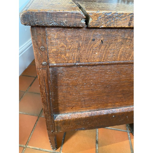 127 - A late 17thC/early 18thC small oak coffer with sunken two panel lid above carved frieze and carved p... 