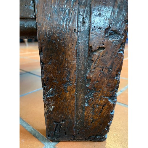 127 - A late 17thC/early 18thC small oak coffer with sunken two panel lid above carved frieze and carved p... 