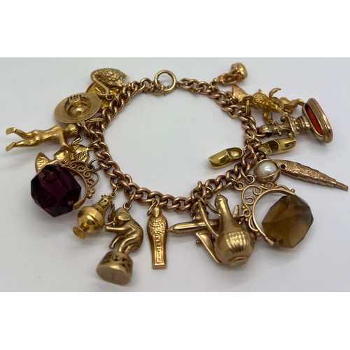 596 - A 9ct gold bracelet with various charms of various carat gold. 79.4gm.