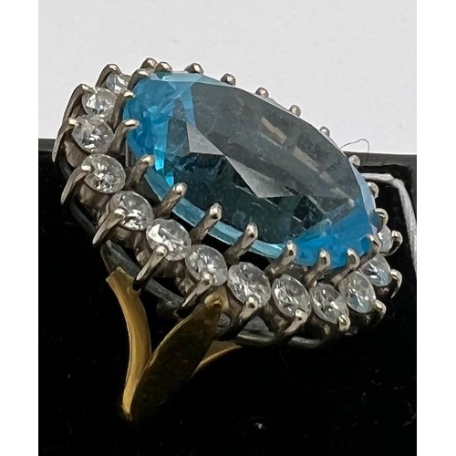 599 - A blue topaz and diamond cocktail ring set in 22 carat gold. The centre topaz surrounded by 20 diamo... 