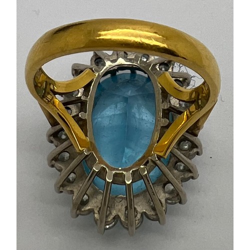 599 - A blue topaz and diamond cocktail ring set in 22 carat gold. The centre topaz surrounded by 20 diamo... 