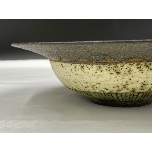 370 - Laurel Keeley (b. 1952) bowl depicting metallic fishes. 26cm d x 7cm h.