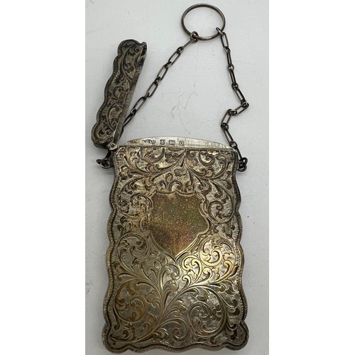 876 - Silver card case with finger ring and foliate scroll engraving. Birmingham 1913, makers mark rubbed.... 