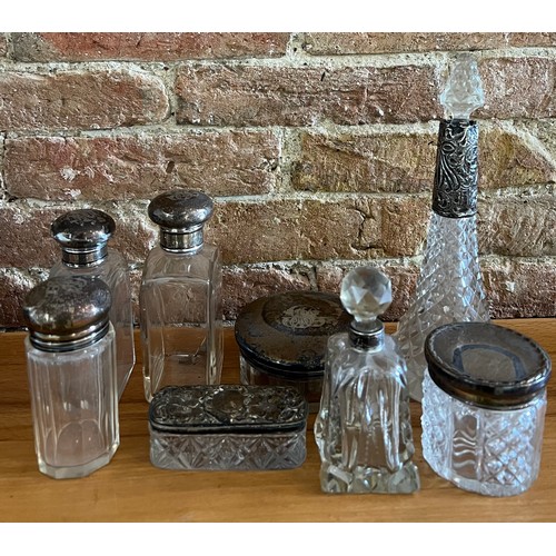 885 - Silver lidded/ collared  glass scent bottles and jars. Various dates and makers.