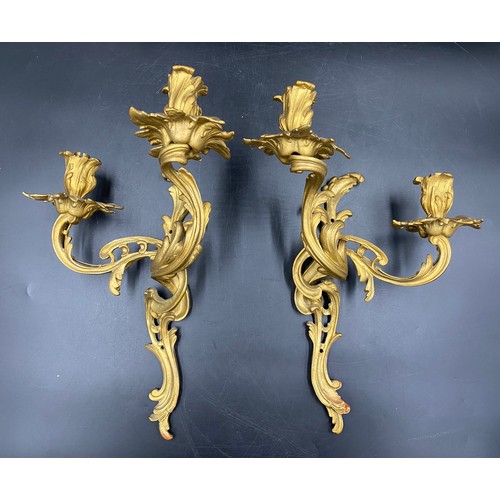 1072 - A pair of French metal and gilt two branch wall sconces. 37cm h approx.