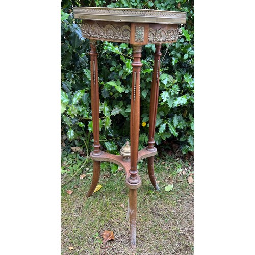 130 - Continental marble topped table with brass galleried top and decorative brass fittings.