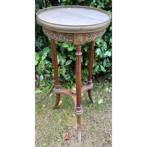 130 - Continental marble topped table with brass galleried top and decorative brass fittings.