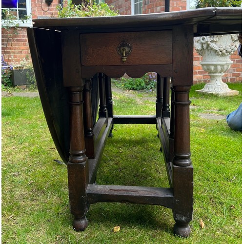 134 - Oak gate leg table with drawer to each end. 143 x 183cm open x 74.5cm h.