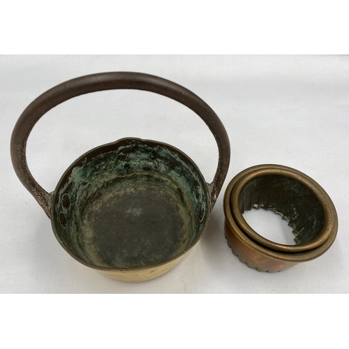 936 - Small brass pan 18cm to top of handle x 13cm d and 2 heavy brass pastry cutters, largest 8cm d.